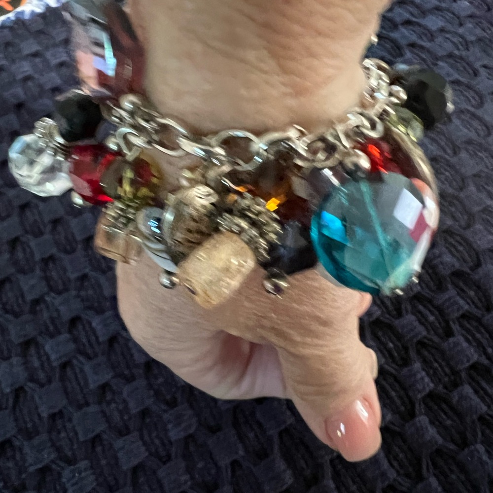 Winner winner this charm bracelet is so much fun.  Glass and silver tone charms